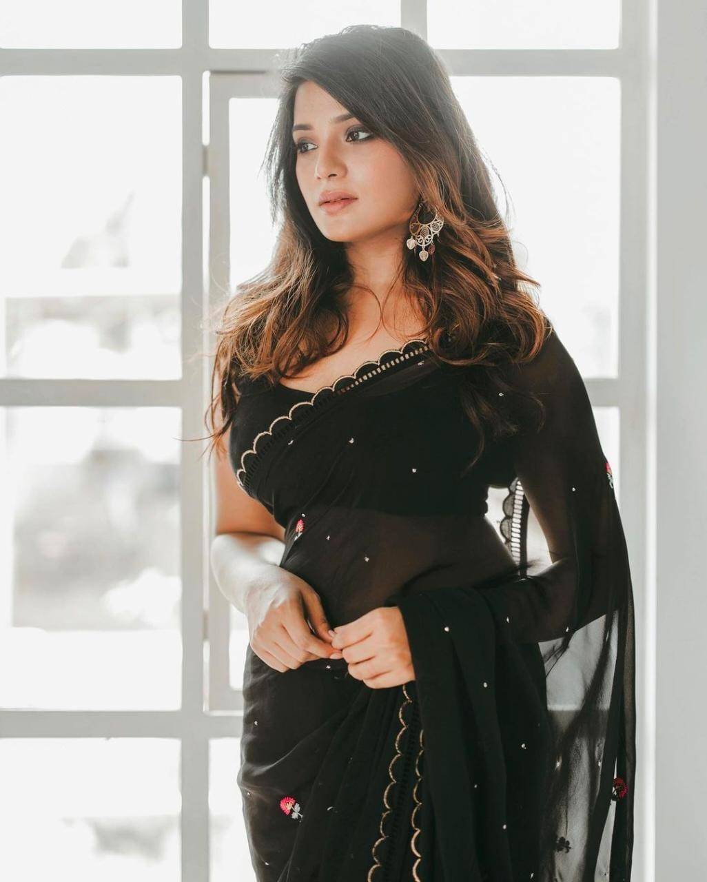 Actress Aathmika Looks ethereal as she casts a spell in a black georgette saree