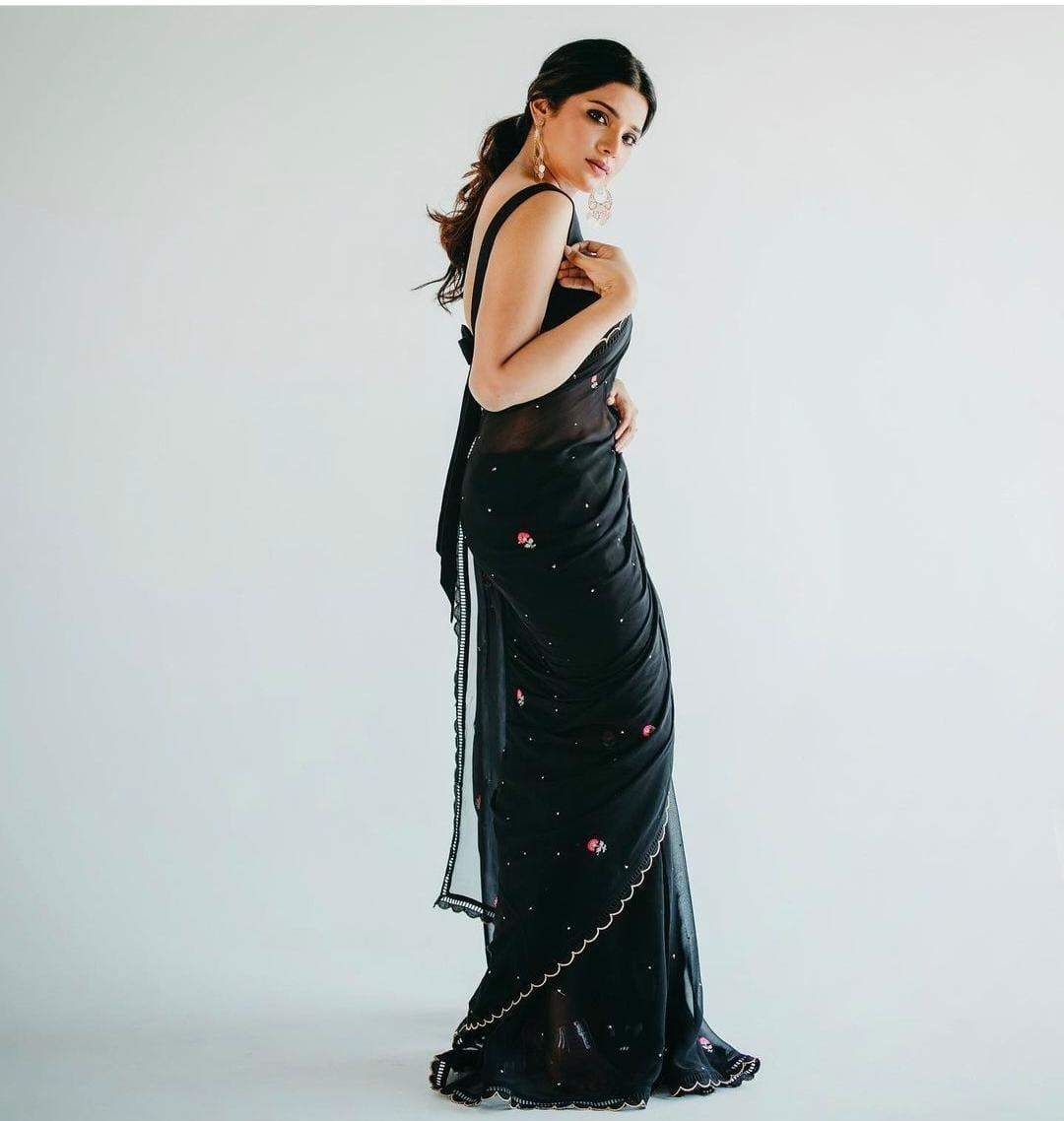 Actress Aathmika Looks ethereal as she casts a spell in a black georgette saree