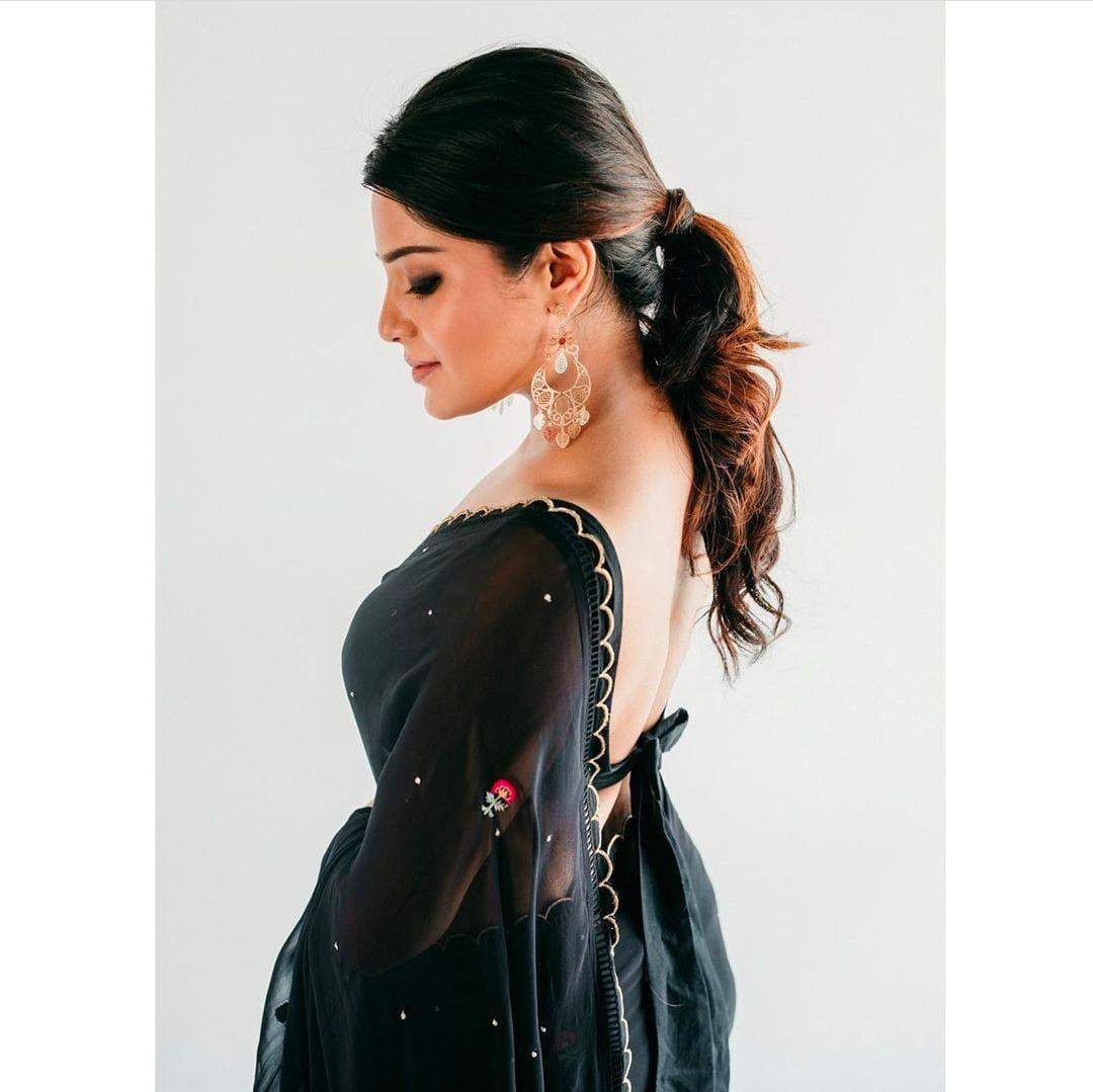 Actress Aathmika Looks ethereal as she casts a spell in a black georgette saree